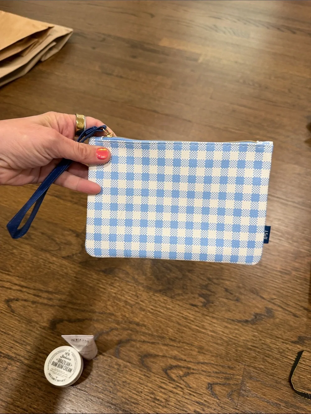 Gingham Wristlet with 2 body creams, 2 eye masks, 3 clarins lip oil samples